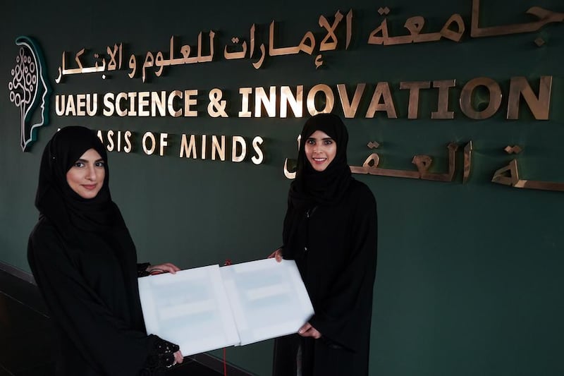 Razan Kharouf, left, and Hamda Al Derei, two of four UAE University graduates in Al Ain, who have developed a carpet that can generate electric charge when walked on it.  Delores Johnson / The National  