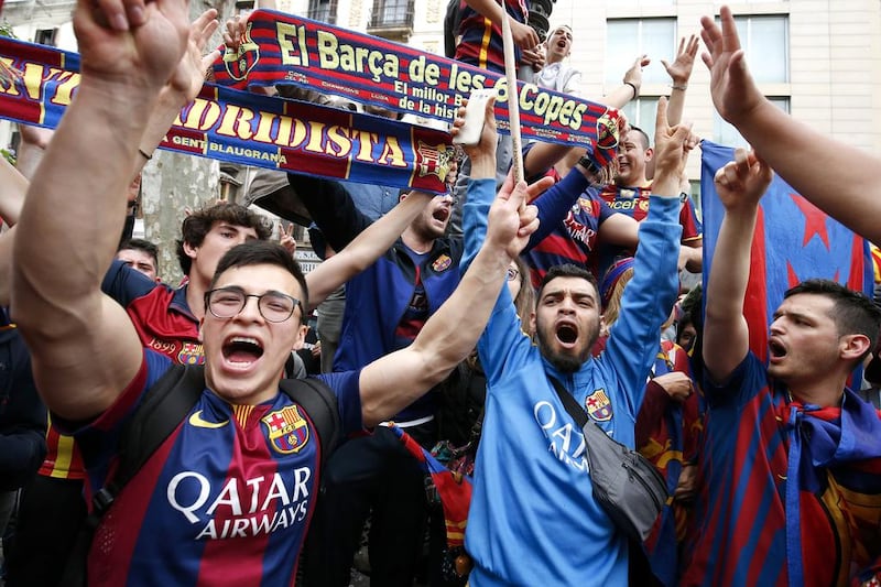 FC Barcelona's supporters celebrate their team's 24th La Liga title at the Canaletes fountain on Las Ramblas in Barcelona, on May 14, 2016. AFP