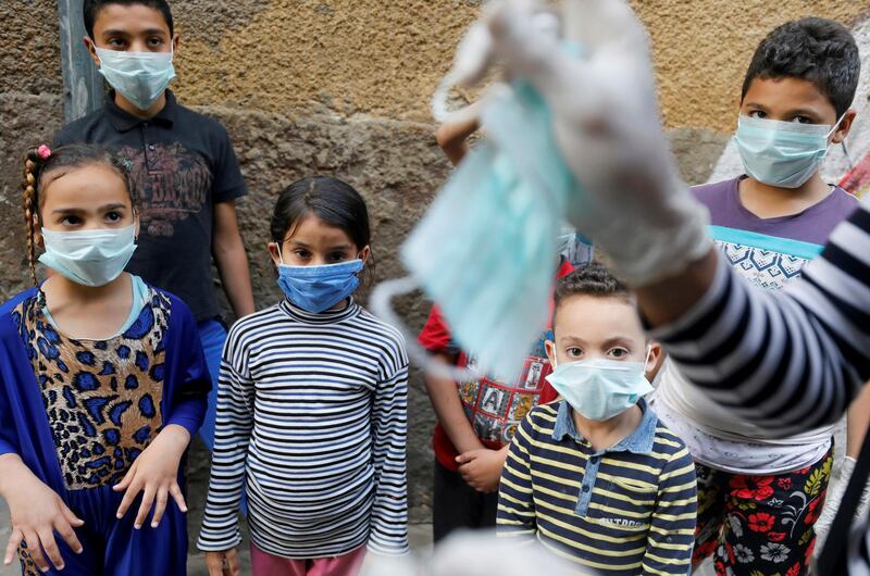 Egyptian clown Ahmed Naser performs to entertain and help children to put on face masks as a preventive measure amid concerns about the spread of the coronavirus disease in Darb Al-Ban district of Cairo. Reuters