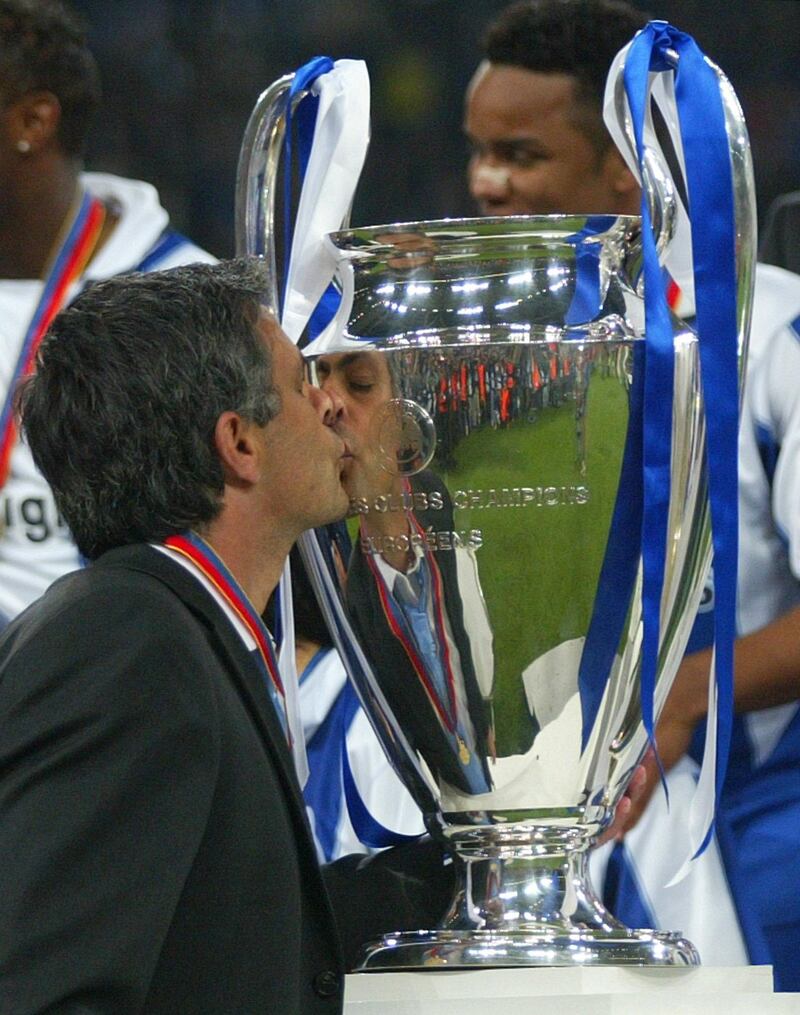 Porto's coach Jose Mourinho kisses the trophy during the presentation ceremony after his team beat Monaco 3-0 to win the UEFA Champions League Final in the 'Arena AufSchalke' in Gelsenkirchen, Germany, Wednesday, May 26, 2004. (AP Photo/Thomas Kienzle)