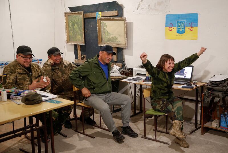 Members of the Ukrainian military celebrate Kalush Orchestra winning the Eurovision Song Contest, at their position in the Kyiv region. Reuters