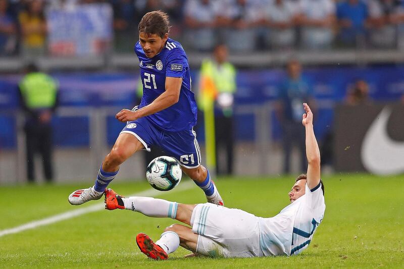 Argentina's Giovani Lo Celso, bottom, vies for the ball with Paraguay's Oscar Romero Villamayor. EPA