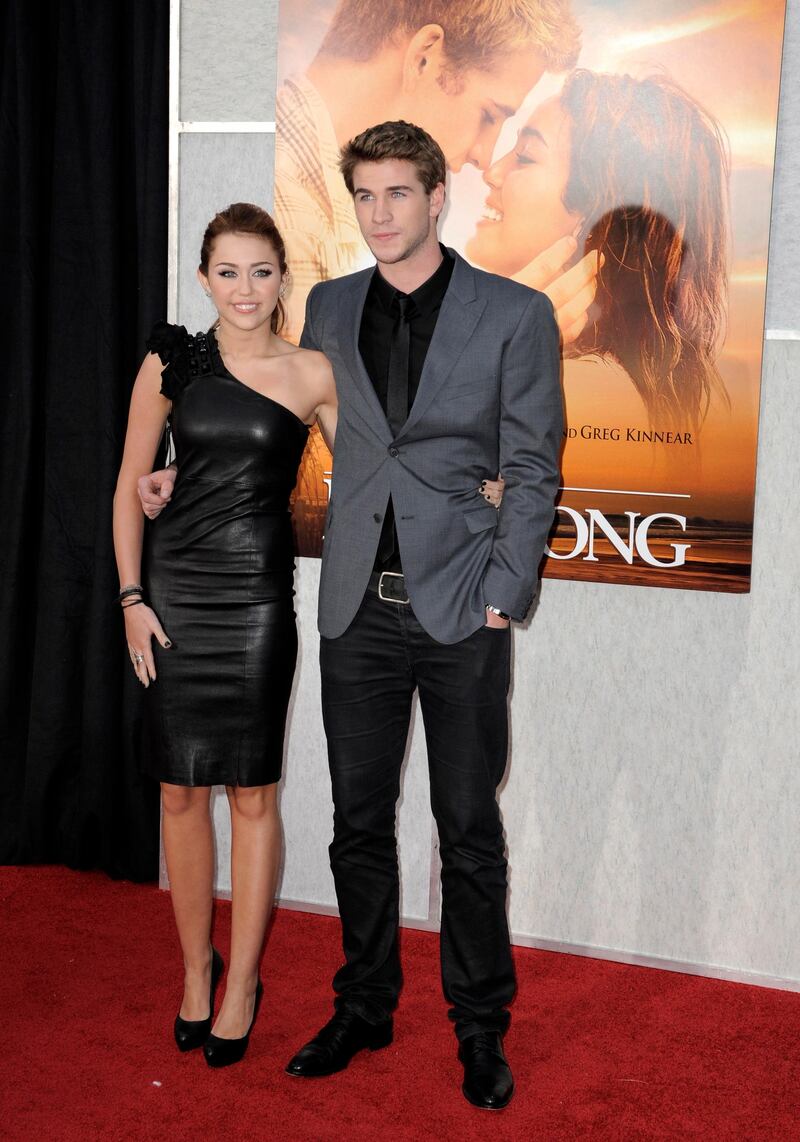 epa02092950 US actress and cast member Miley Cyrus (L) and Australian actor Liam Hemsworth (R) arrive for the premiere of 'The Last Song' in Hollywood, California, USA, 25 March 2010. Cyrus plays the role of 'Ronnie Miller' and Hemsworth plays the role of 'Will Blakelee' in this story of first love. Miley Cyrus wears a leather dress by Thomas Wylde. EPA/PAUL BUCK
