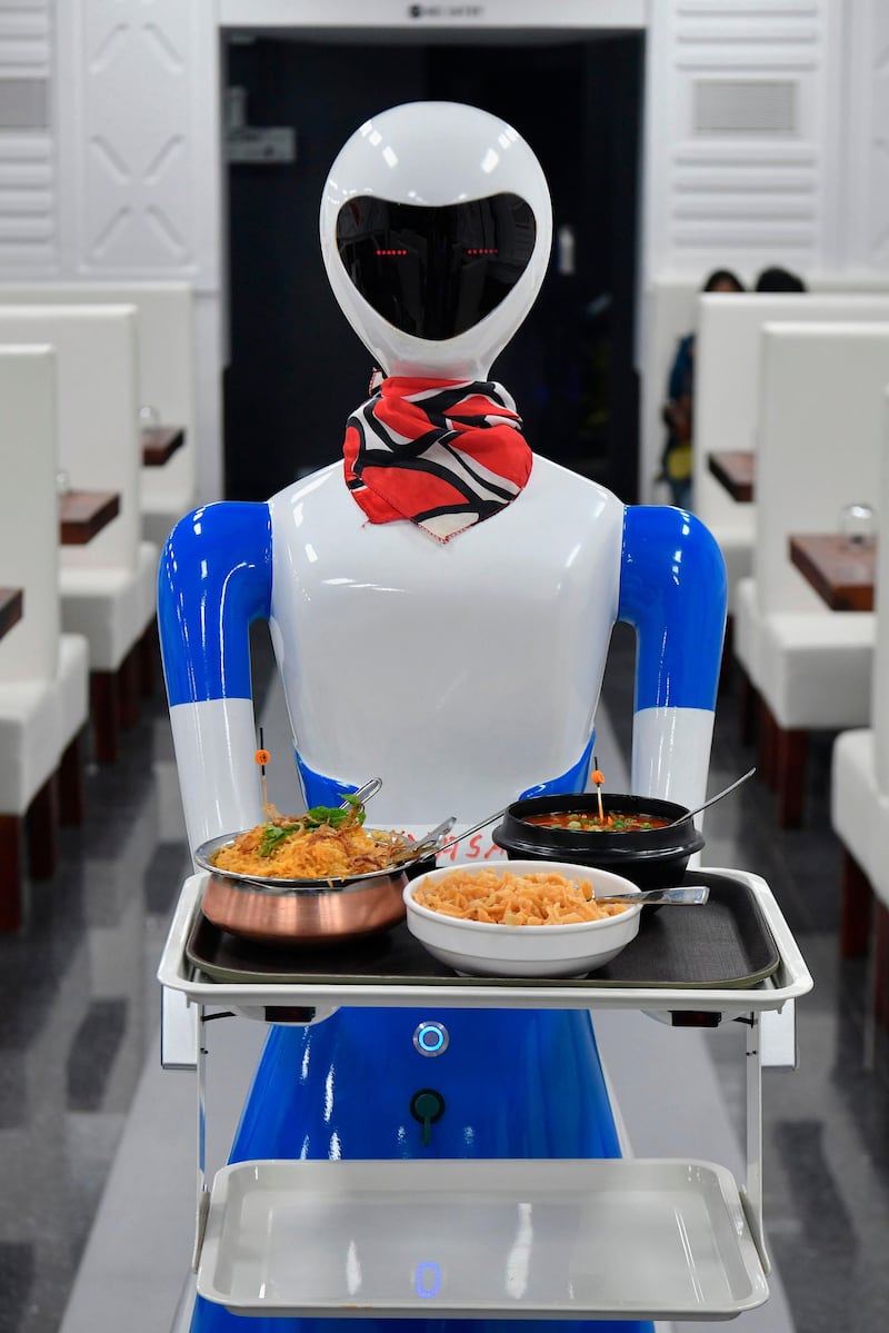 A service robot carries food in a tray for customers on the opening day of the "Robot" restaurant in Bangalore on August 17, 2019. Photo: AFP