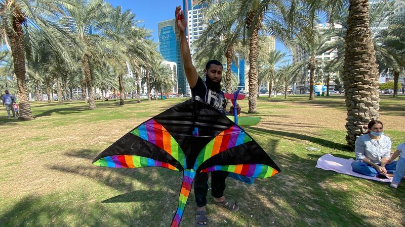 A man tries to fly a colourful kite on the Buhaira Corniche.