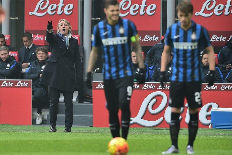 This file photo taken on January 24, 2016 shows Inter Milan's manager Roberto Mancini gesturing during an Italian Serie A match against Carpi at San Siro Stadium in Milan. Inter Milan said on August 8, 2016 its coach Roberto Mancini is leaving, citing a "mutual agreement" amid media reports the Serie A club's new Chinese owners decided fresh blood is needed to rejuvenate the team. AFP / GIUSEPPE CACACE