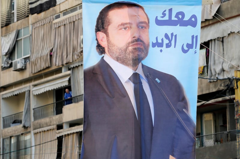 A poster depicting Lebanon's Prime Minister Saad al-Hariri, who has resigned from his post, hangs along a street in the mainly Sunni Beirut neighbourhood of Tariq al-Jadideh in Beirut, Lebanon November 6, 2017. The Arabic on the poster reads, "With you forever". REUTERS/Mohamed Azakir NO RESALES. NO ARCHIVES.