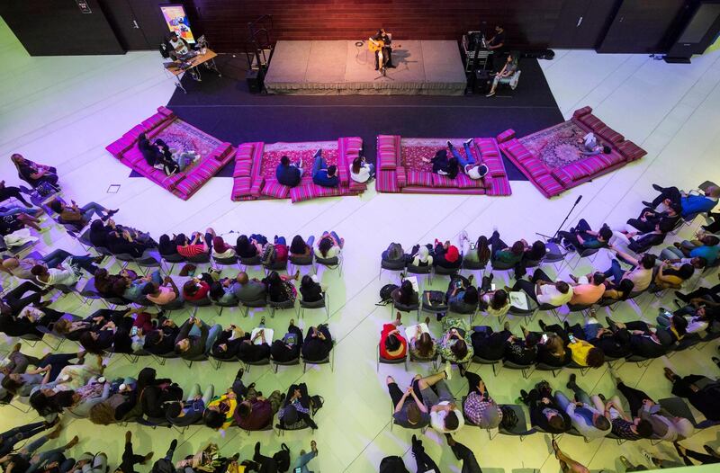 Abu Dhabi, United Arab Emirates- Audiences watching performer on stage at the Rooftop Rhythms Spoken Word at NYUAD Arts Centre Lobby, Saadiyat.  Ruel Pableo for The National