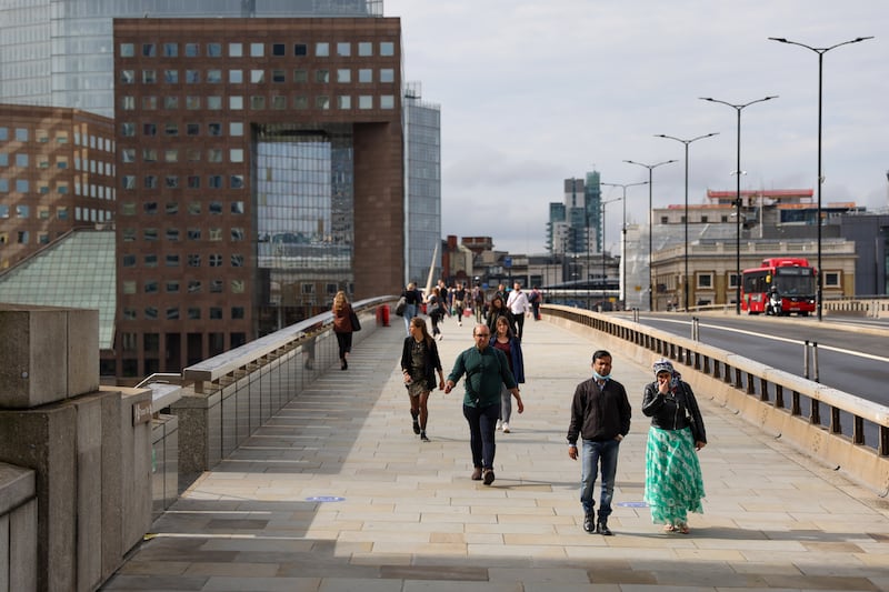 Pedestrians cross London Bridge, as England approaches its so-called Freedom Day on July 19.