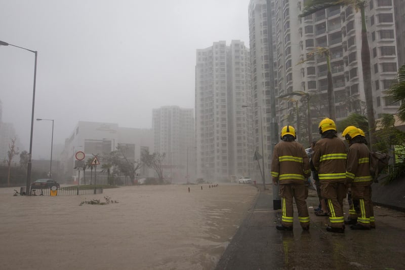 Firemen look on at the flooded Heng Fa Chuen housing estate in Hong Kong. EPA