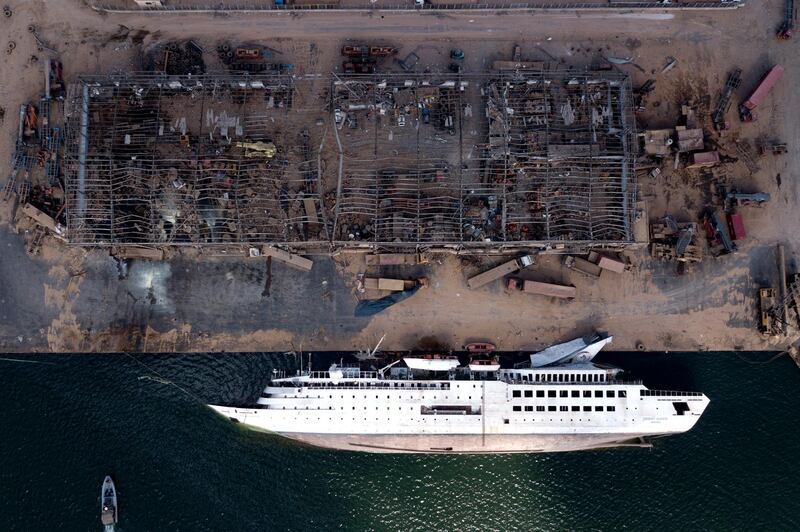 epa08598952 A picture taken with a drone shows a capsized ship lies at port area four days after explosions that hit Beirut port, in Beirut, Lebanon, 08 August 2020 (issued 12 August 2020). Lebanese Health Ministry said at least 171 people were killed, and more than 6000 injured in the Beirut blast that devastated the port area on 04 August and believed to have been caused by an estimated 2,750 tons of ammonium nitrate stored in a warehouse..  EPA/STR