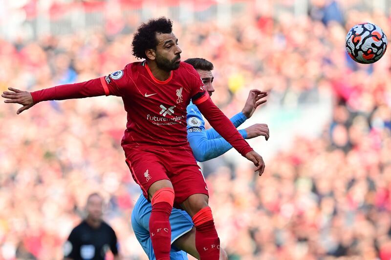 Manchester City's Aymeric Laporte challenges Liverpool's Mohamed Salah. AFP