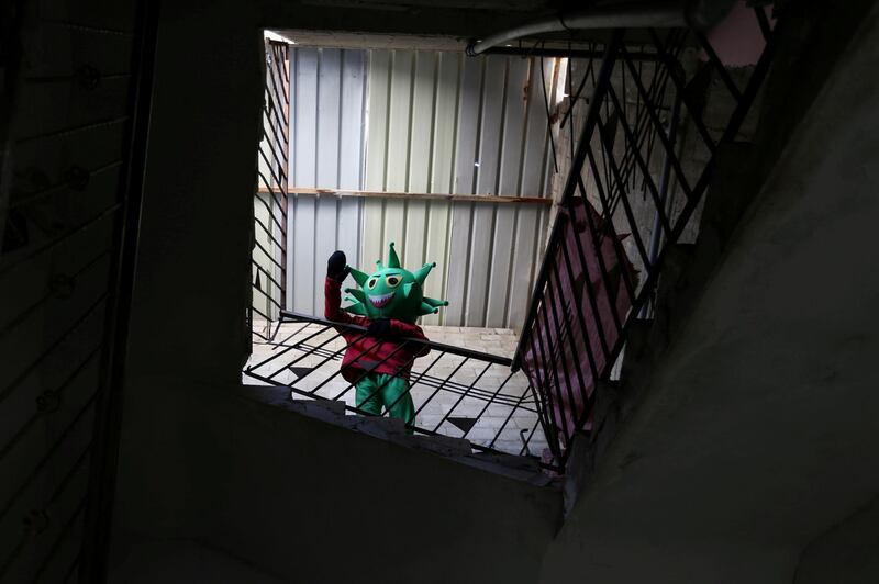 A Palestinian boy gestures as he wears a costume, sewed by his mother, representing the microscopic view of the coronavirus in the central Gaza Strip. Reuters