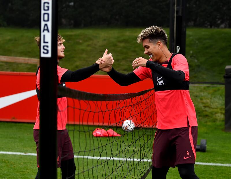 Roberto Firmino and Harvey Elliott of Liverpool during a training session at AXA Training Centre in Kirkby, England. 