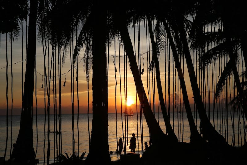 Tourists watch the sunset a day before the government implements the temporary closure of the country's most famous beach resort island of Boracay, in central Aklan province, Philippines, on Wednesday, April 25, 2018. Aaron Favila / AP Photo