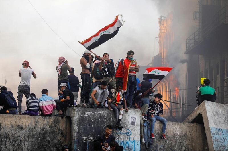 An Iraqi demonstrator carries the Iraqi flag during ongoing anti-government protests, in Baghdad. REUTERS