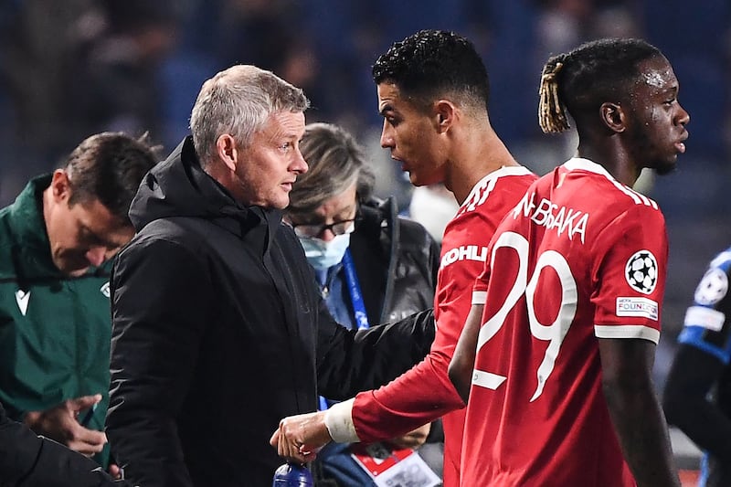 Manchester United forward Cristiano Ronaldo speaks with manager Ole Gunnar Solskjaer during the Champions League match against Atalanta. Ronaldo's brace in the 2-2 draw saw him overtake Solskjaer in United's all-time scoring charts with 127 goals. EPA