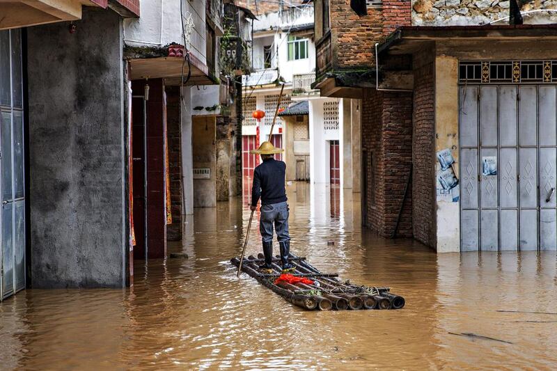 A villager rows a bamboo raft along a flooded street in Taohua village after strong rainfalls in Meizhou, Guangdong Province, China. Reuters / Stringer