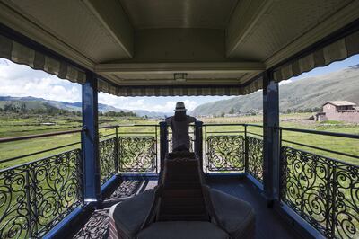 A passenger in the observation car as South America’s first luxury sleeper train, Belmond Andean Explorer, passes through the Cusco region of Peru, during its journey between Arequipa, Lake Titicaca and Cusco. The train cuts through some of the most breathtaking scenery in Peru and features 24 cabins, Peruvian cuisine by Executive Chef Diego Munoz, an elegant piano bar and outdoor observation car. Picture credit should read: Matt Crossick