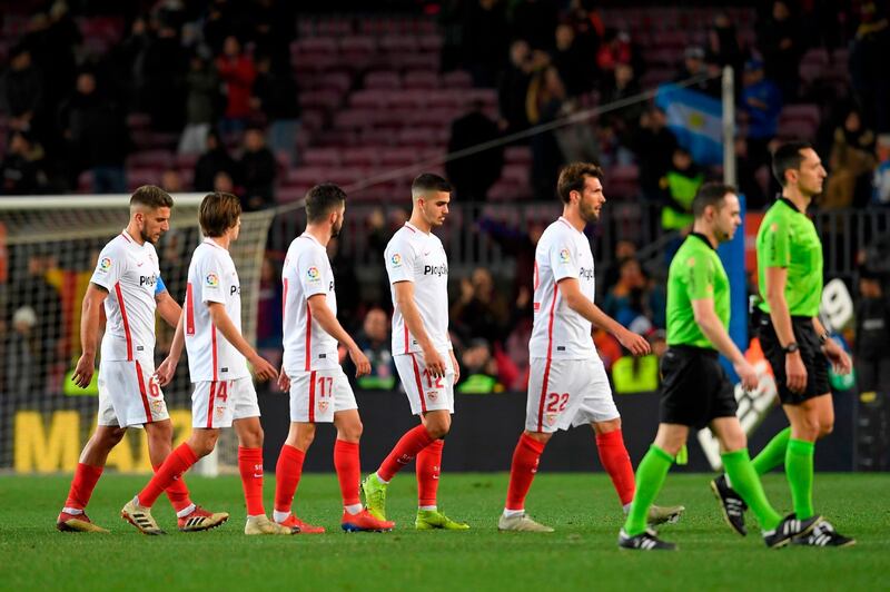 Sevilla players leave the pitch after their heavy defeat. AFP