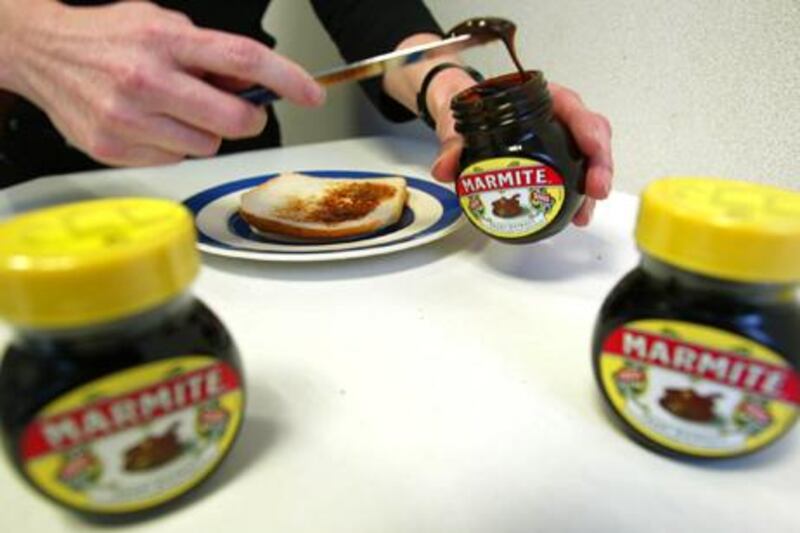 Marmite, the traditional British vegetable paste, is spread on a slice of bread during a lunch break in London, 22 February 2002. The brand celebrates its 100th birthday this year.