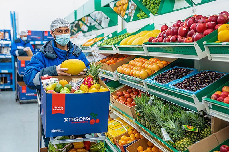 Staff select food for delivery at Kibsons supply warehouse in Dubai's International City, which had to close after a coolant leak.