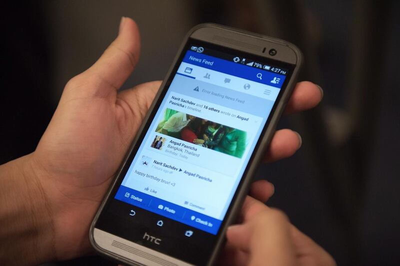 A man check his Facebook on his smart phone. Nicolas Asfouri / AFP  



