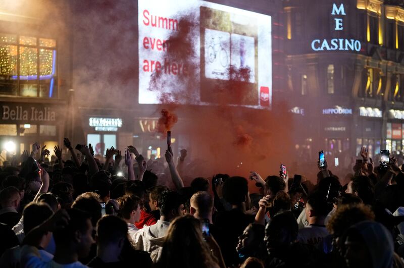 England supporters celebrate in Leicester Square,