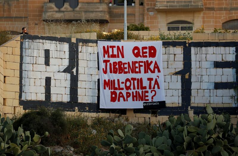 A protest banner reading "Who is benefitting from Daphne's murder?", referring to the assassination of anti-corruption journalist Daphne Caruana Galizia in October 2017, hangs over a tunnel entrance in St Julian's, Malta April 23, 2018.  REUTERS/Darrin Zammit Lupi