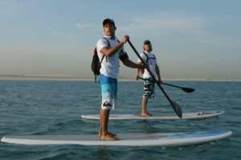DUBAI - DECEMBER 6,2009 - Surfer Scott Chambers and Daniel Van Dooren surf around the World Island to raise money for the victims of Tsunami .( Paulo Vecina/The National ) *** Local Caption ***  PV Surf 3.jpg