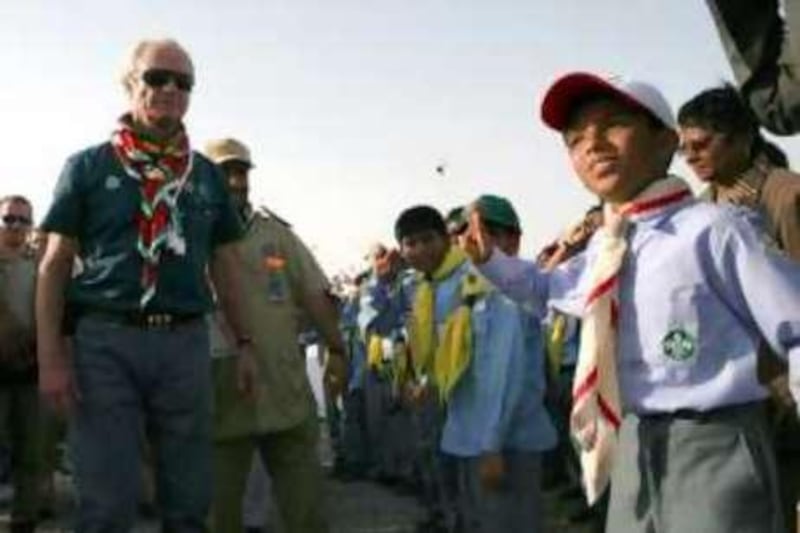 AL SHARJA - OCTOBER 24,2008 - HIs Majesty King Carl Gustaf, King of Sweden ( wearing green polo ) receive a scout salute from a scout  during visit at Scout Camp in Sharja. ( Paulo Vecina/The National ) *** Local Caption ***  PV Scout 14.JPG