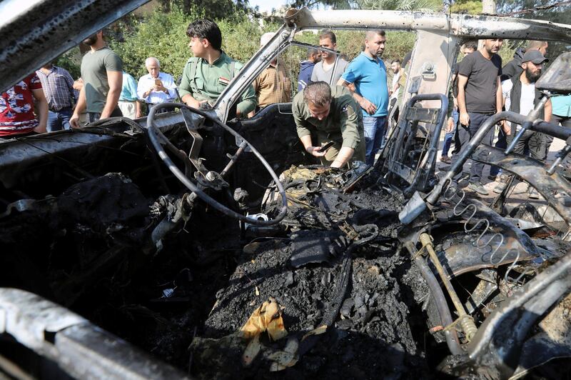 Members of the Syrian regime inspect the location where a car bomb exploded in the northeastern Syrian town of Qamishli which is mainly controlled by Kurdish forces, in the town of Qamishli, Syria. REUTERS