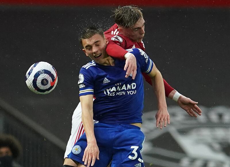 Leicester's Luke Thomas and Brandon Williams of United challenge for a header. Reuters