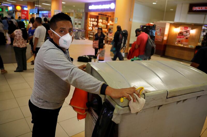 A sanitation worker wears a protective face mask after a case of coronavirus was confirmed in the country, at Jorge Chavez International Airport in Lima, Peru. REUTERS