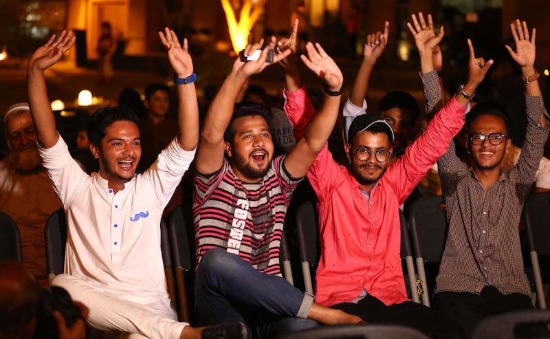 epa07041892 Cricket supporters watch a cricket match between India and Pakistan during the group matches in Asia Cup on screens displayed at a restaurant in Karachi, Pakistan, 23 September 2018.  EPA/SHAHZAIB AKBER