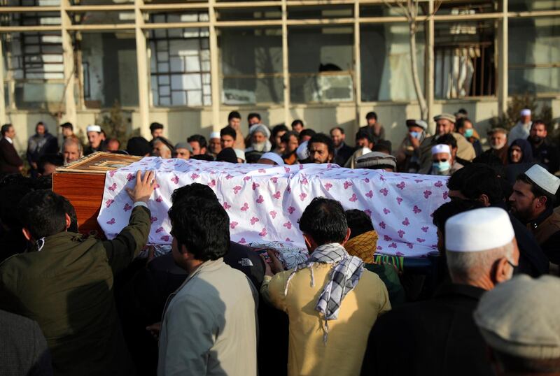 Afghan people carry the coffin of Mohammad Yousuf Rasheed, executive director of the non-governmental Free and Fair Election Forum of Afghanistan, during his funeral ceremony, in Kabul, Afghanistan, Wednesday, Dec. 23, 2020. Separate bombing and shooting attacks in Afghanistanâ€™s capital left several people dead Wednesday, including Rasheed, the head of the independent elections watchdog, officials said. (AP Photo/Rahmat Gul)