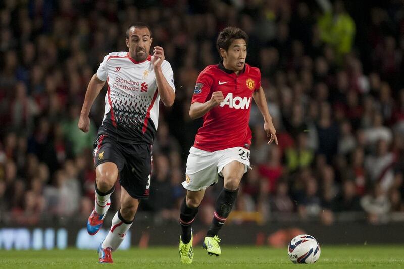 Manchester United's Shinji Kagawa, right, keeps the ball from Liverpool's Jose Enrique during their English League Cup soccer match at Old Trafford Stadium, Manchester, England, Wednesday Sept. 25, 2013. (AP Photo/Jon Super) *** Local Caption ***  Britain Soccer League Cup.JPEG-0d14c.jpg