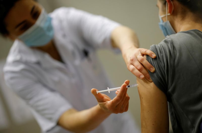 A healthcare worker administers a dose of the "Comirnaty" Pfizer BioNTech COVID-19 vaccine at the Parc des Expositions in Angers as part of the coronavirus disease (COVID-19) vaccination campaign in France, April 13, 2021. REUTERS/Stephane Mahe