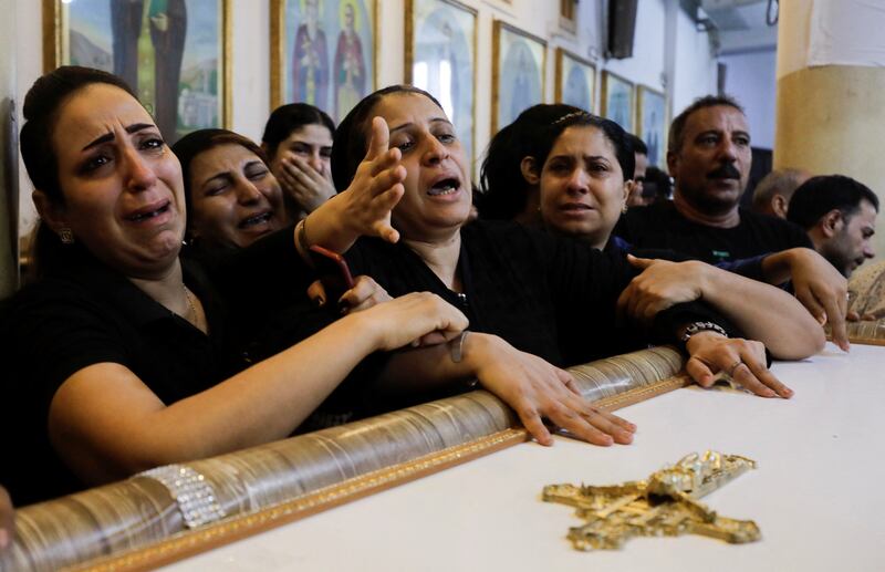 Grieving family members at a joint funeral service. Reuters
