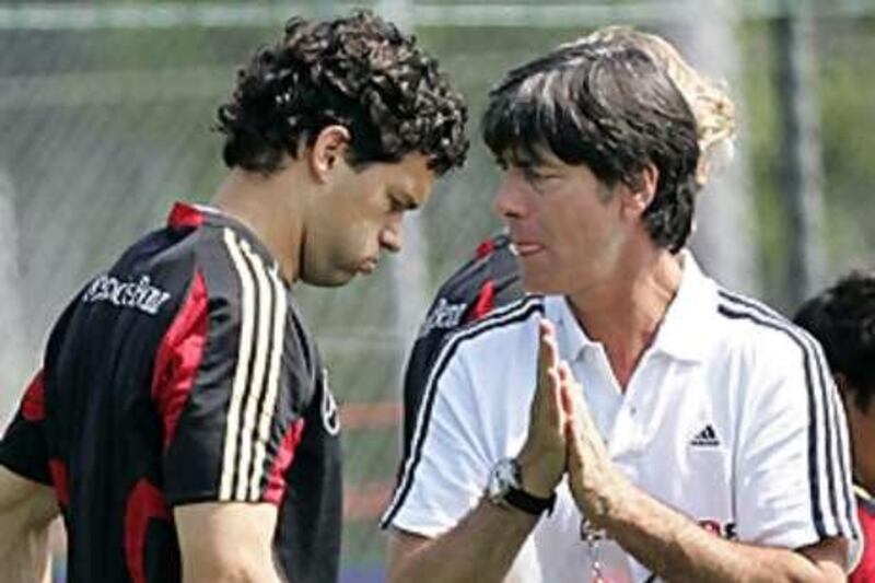 Joachim Low, right, has called for a meeting with his captain Michael Ballack, left, after comments the player made about his national coach.
