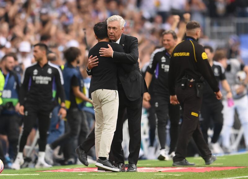 Real coach Carlo Ancelotti embraces  Barca's Xavi after the match. Getty