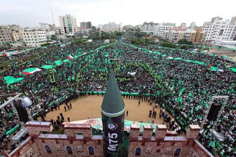 Supporters of Hamas gather during a rallys to mark the 25th anniversary of the founding of the Islamist movement, in Gaza on December 8, 2012. Hamas leader in exile Khaled Meshaal made his first visit to Gaza, timed to coincide with the 25th anniversary of the Islamist movement's founding. AFP PHOTO/MAHMUD HAMS

 *** Local Caption ***  059589-01-08.jpg