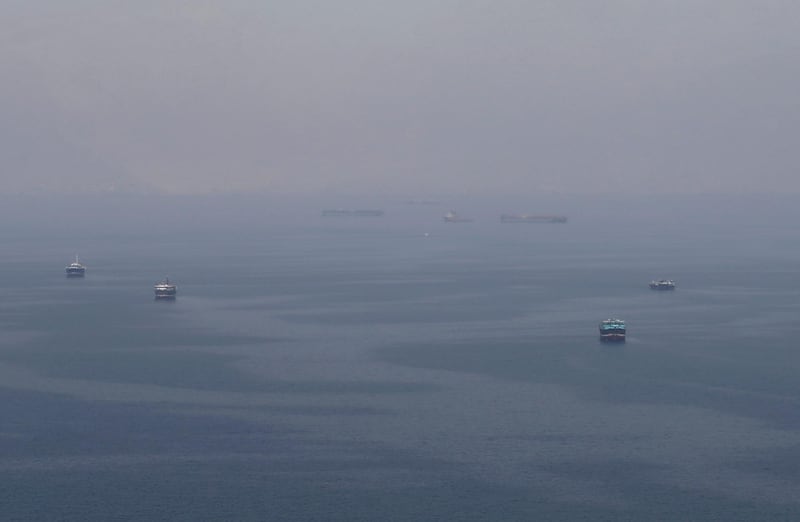 Traditional Omani boats known as dhows, and cargo ships are seen sailing towards the Strait of Hormuz, off the coast of Musandam province, Oman, July 21, 2018. Picture taken July 21, 2018. REUTERS/Hamad I Mohammed