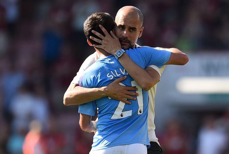 Manchester City manager Pep Guardiola embraces midfielder David Silva, who played his 400th game for Manchester City against Bournemouth. AFP