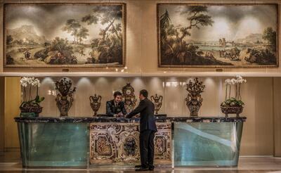 Concierge Desk with Zais painting at Rome Cavalieri Waldorf Astoria. Courtesy Rome Cavalieri Waldorf Astoria