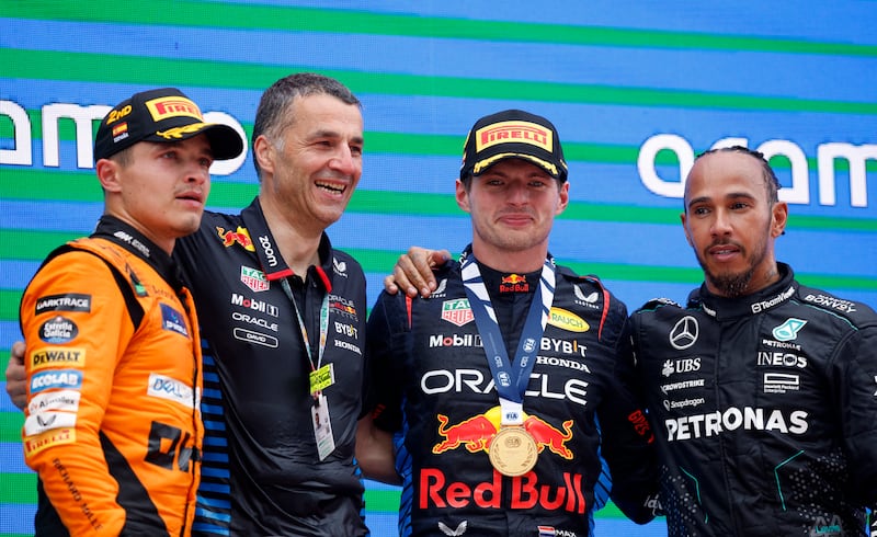 Race winner Max Verstappen on the podium alongside second-placed McLaren's Lando Norris, left, and Mercedes' Lewis Hamilton, right, who was third. Reuters