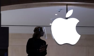 In this Feb. 5, 2021 photo, an Apple store employee wears personal protective equipment in New York.  Big Tech stocks are flexing their enormous strength again, after getting knocked around a bit earlier this year. Apple, Microsoft, Amazon, Google's parent company and Facebook all gave profit reports this week that blew past investors' already high expectations, Friday, April 30.  (AP Photo/Mark Lennihan)