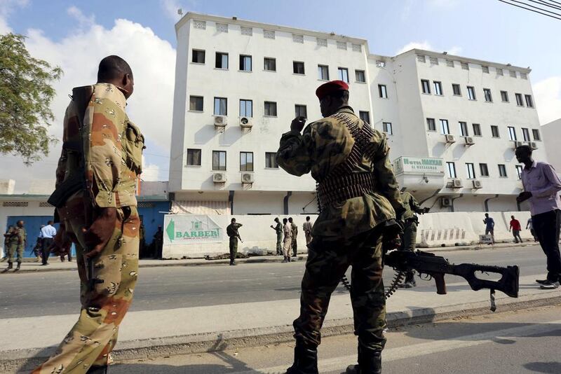 Somali soldiers take position outside the Maka Al Mukarama hotel after an attack by Al Shabaab militants in Mogadishu on March 28, 2015. Feisal Omar / Reuters
