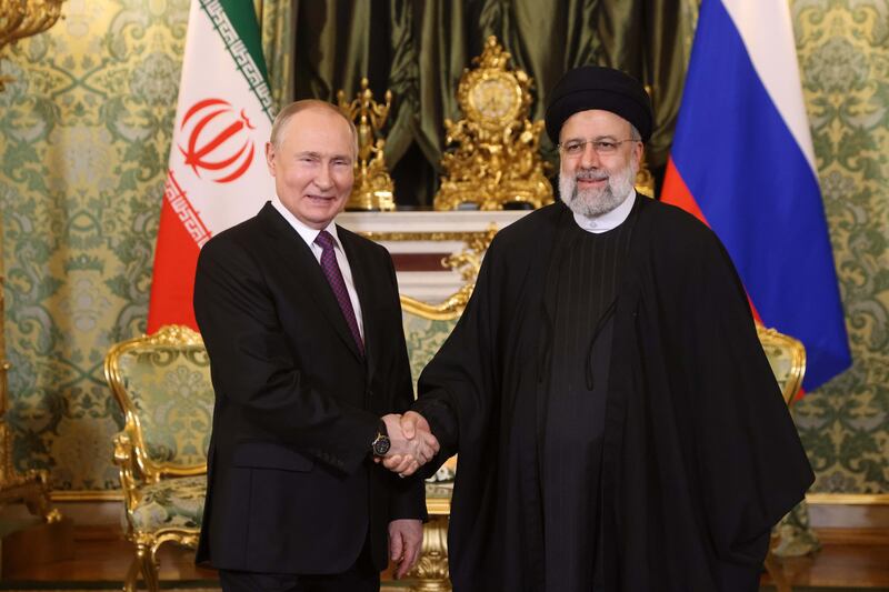 Russian President Vladimir Putin greets Iranian President Ebrahim Raisi during their meeting at the Grand Kremlin Palace in Moscow. Getty Images