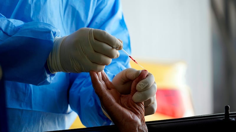 A health worker conducts a coronavirus test at a drive-through testing centre in the central Iraqi city of Najaf.  AFP